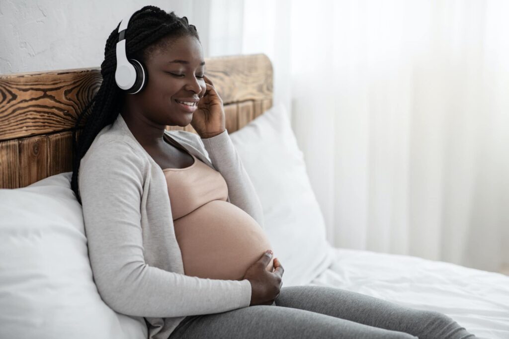 Calm Black Pregnant Woman Listening Pregnancy music